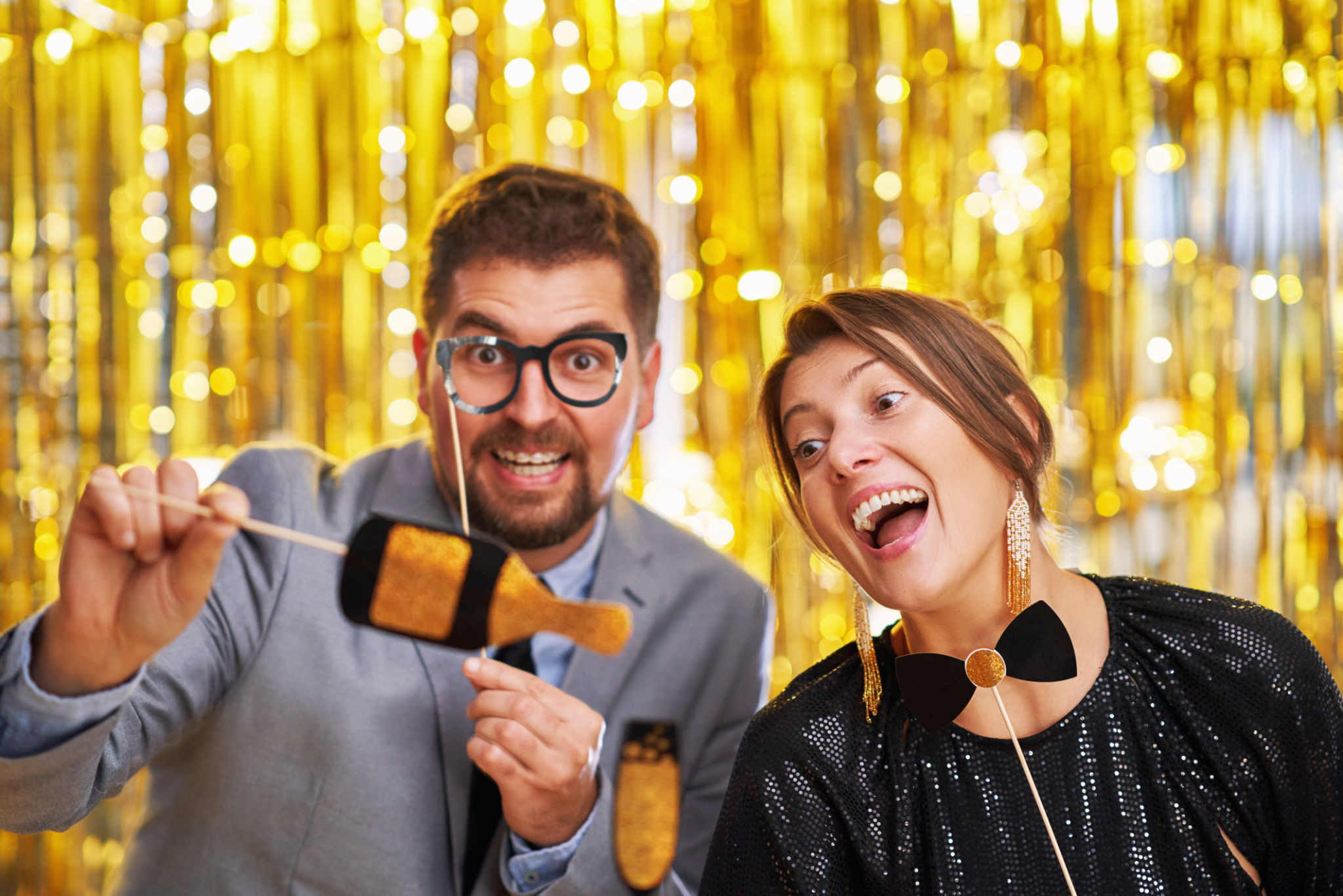 Couple over gold with photo booth accessories on party. High quality photo